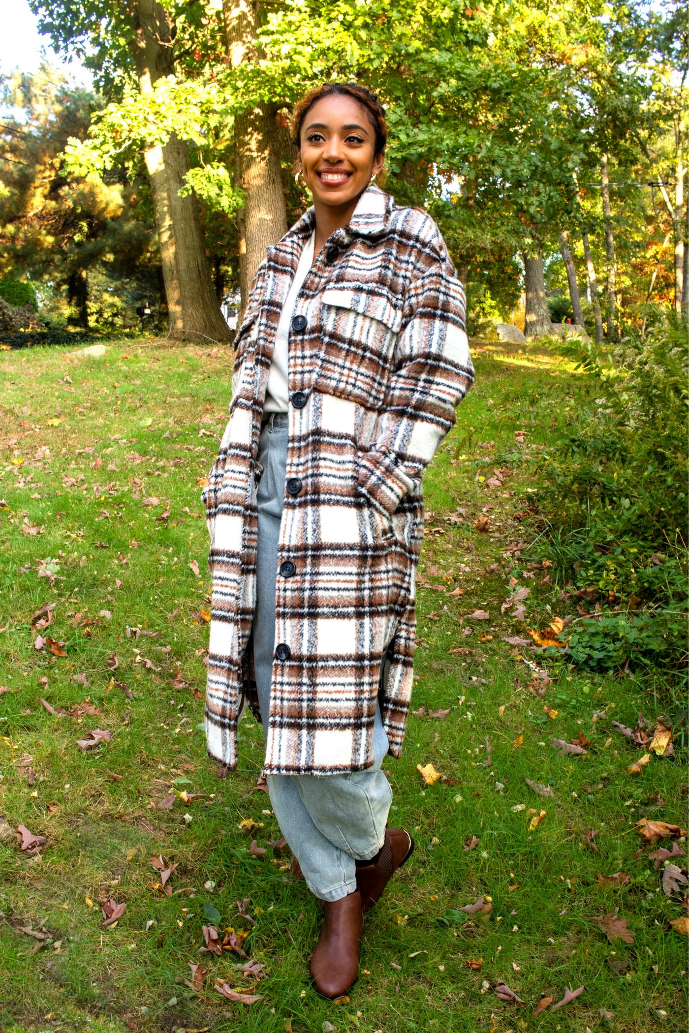 White mid length shacket coat with black and brown plaid detailing. Black buttons and collared neck.