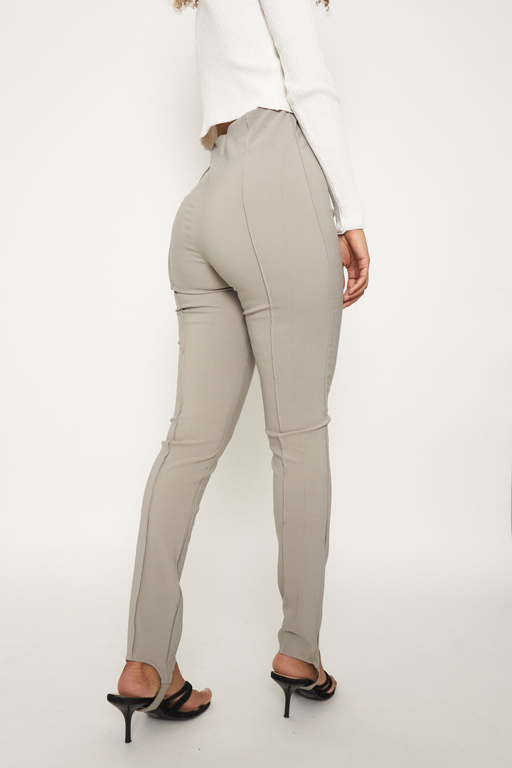 Grey, high-waisted, pleated stirrup leggings.