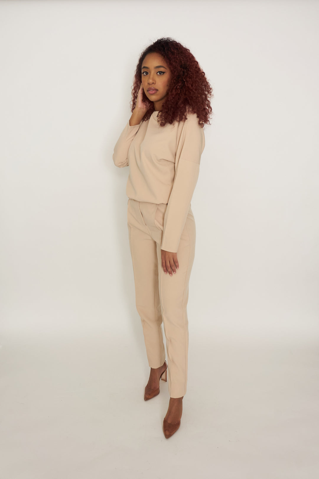 The Classy Girl Set is beige and comes with a long sleeve top that has a waistband bottom to always give the “tucked-in'' look without needing to tuck in the top. The bottoms come with zipper and button front with belt loops,