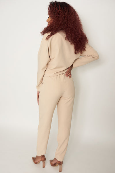 The Classy Girl Set is beige and comes with a long sleeve top that has a waistband bottom to always give the “tucked-in'' look without needing to tuck in the top. The bottoms come with zipper and button front with belt loops,